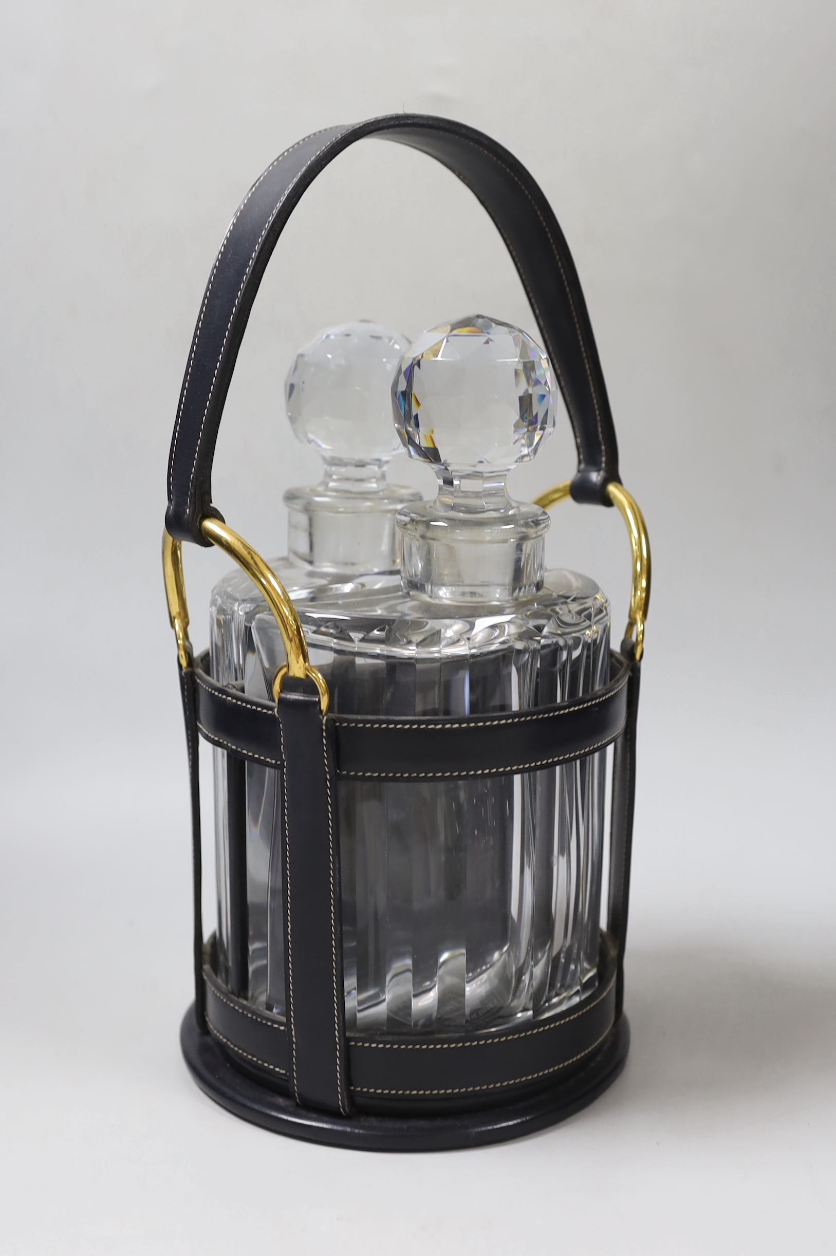 An Hermes black leather decanter set, fitted with two Baccarat glass decanters